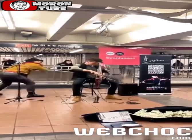 Video :A musician is struck from behind by a lady